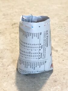 finished newspaper pot for seedling on marble table