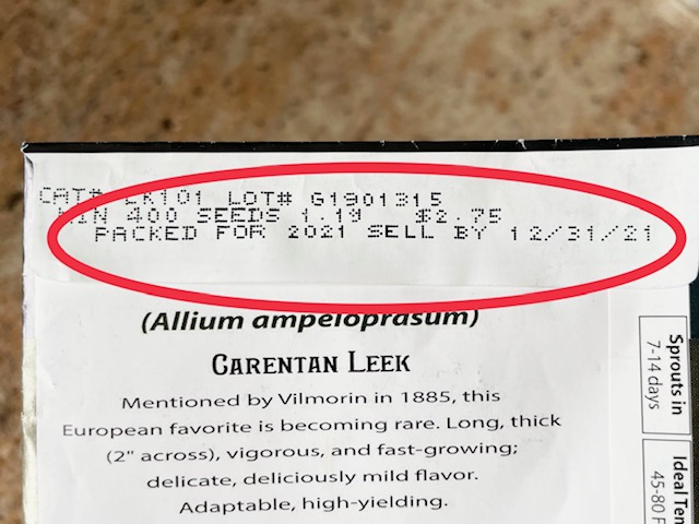 Sell by date of December 31, 2021 circled in red on a packet of leek seeds.