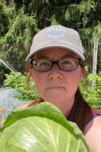 selfie with garden cabbage of Liz Will from Learn To Grow Gardens